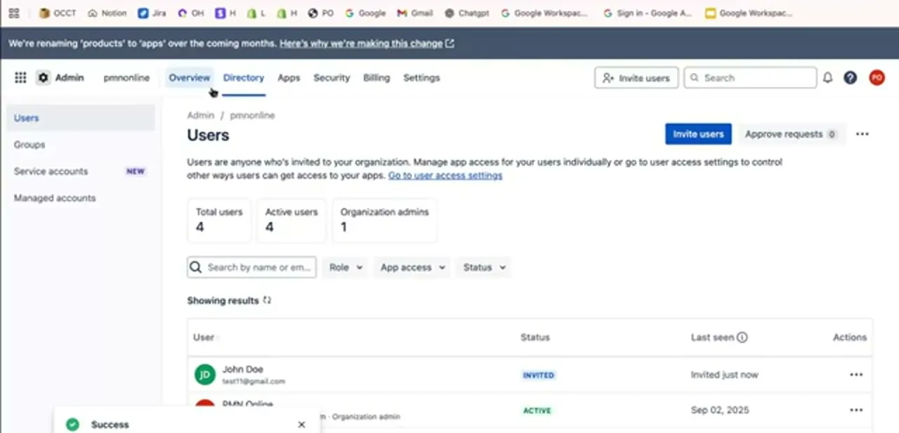 The organization's Users page after an invite is sent — the new account appears with an Invited status, and a success confirmation shows the invite went out.