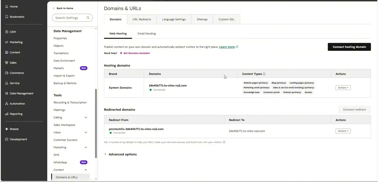 The Domains & URLs page under Web Hosting, showing the default system domain plus a redirected domain and the Connect hosting domain button.