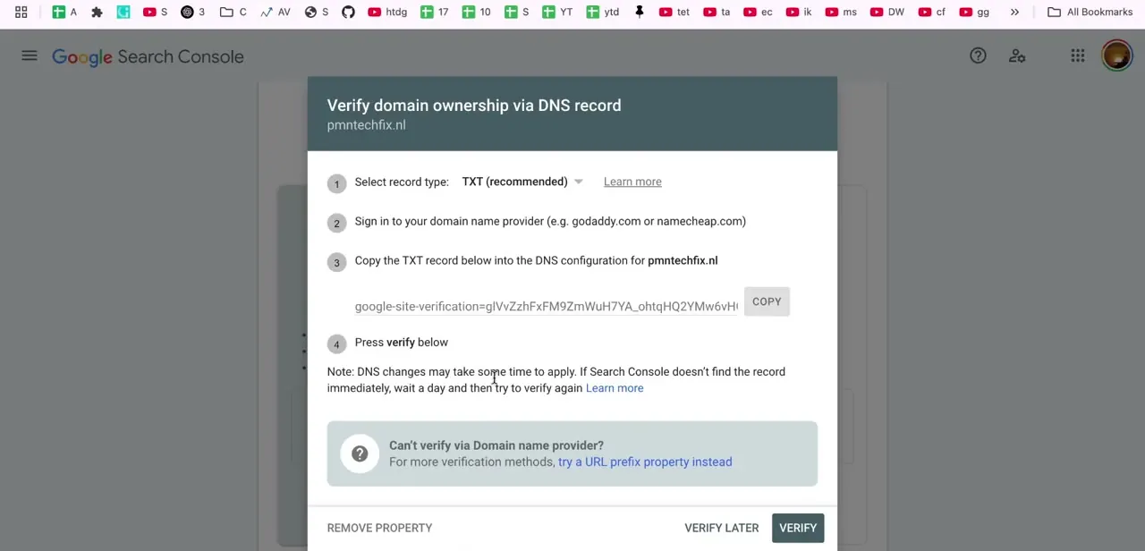 Search Console's "Verify domain ownership via DNS record" dialog, with the TXT record method selected and the verification string ready to copy.