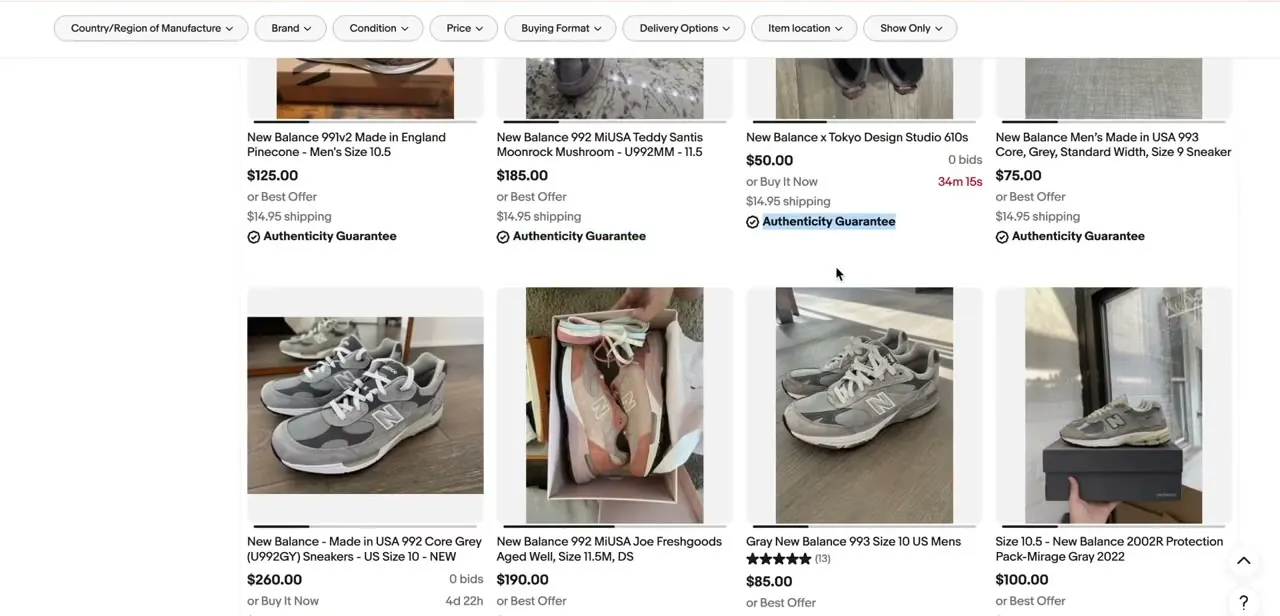 Search results for New Balance sneakers, with an Authenticity Guarantee checkmark shown directly under several listings, buyers see this badge before they ever open the item page.