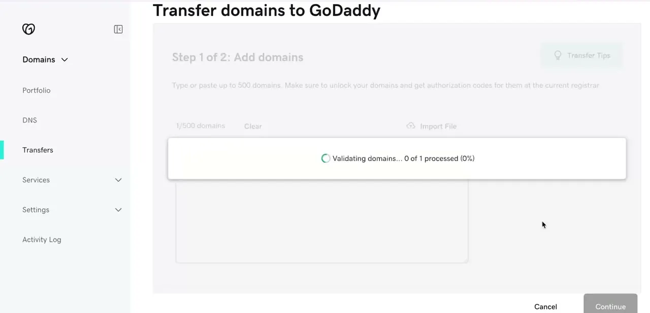 Step 1 of GoDaddy's transfer wizard, validating a domain against the registry before it can proceed to the authorization code step.